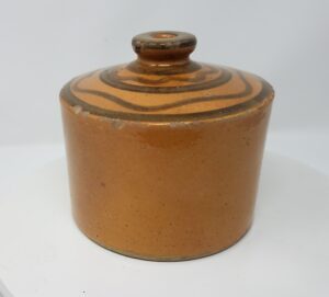 Whitewater Countertop String Holder with lead glaze inside and out and manganese lines encircling the knob, which has a hole for the string.  Private collection.