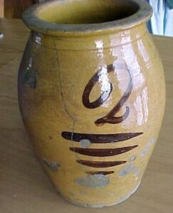 Whitewater ovoid food storage jar with clear lead glaze, two-gallon capacity. It has a large brushed "2" over four lines, Private collection.