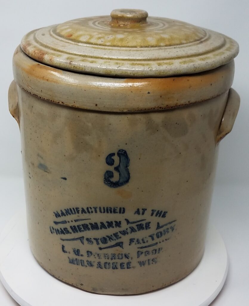 Salt glazed crock with cobalt stencil from the 1882-1886 period when Louis Pierron was the general manager of the pottery.  Lid was dug separately but has a similar "orange peel" salt glaze seen on many pieces from this factory.