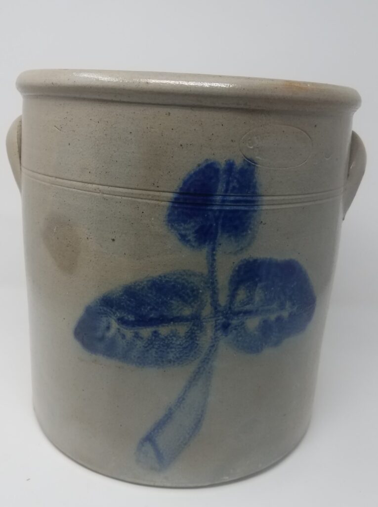 The cobalt flower on this straight-sided crock resembles decorations painted by C. Dauffenbach about 1865-1867 before he went to New Ulm. A capacity is not visible but the crock appears to be a three-gallon capacity.