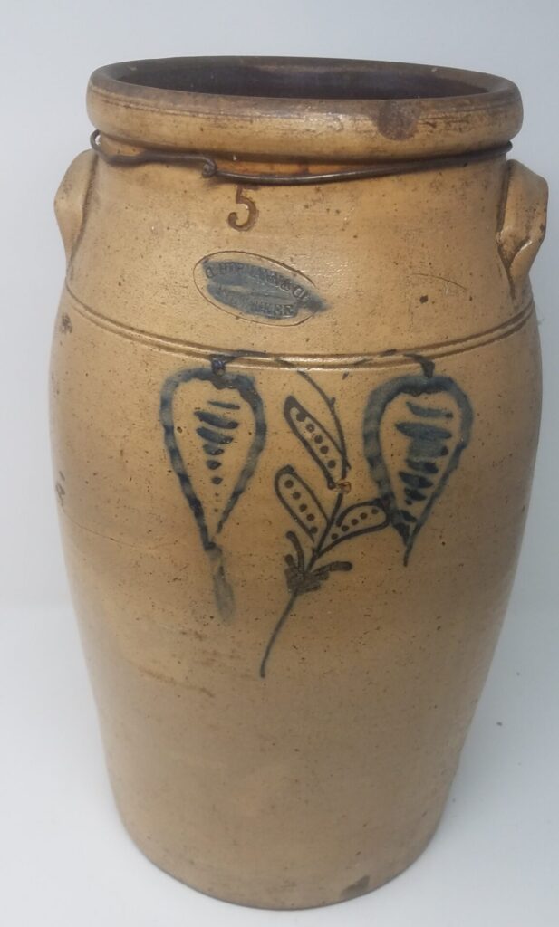 Slip cup and brushed on decoration. Quite delicate rendering and appears to be the "Dot" artist.