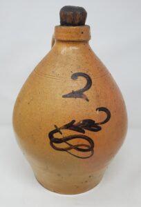 Two-gallon Whitewater ovoid jug with manganese fern with a sinuous tail. We attribute this piece to the Depot or Fremont Street Pottery. Private collection.