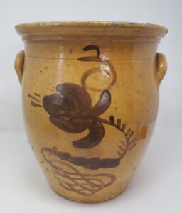 Three-gallon Whitewater cream pot with elaborate manganese decoration with a flower, fern, and scroll. It has strong similarities to pieces recovered from the Baraboo Pottery waster dump. From the collection of the Whitewater Historical Society.