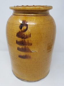 Whitewater food storage jar with clear lead glaze, two-gallon capacity. It was fired upside-down and the lead glaze and decoration ran glaze dripped. From the collection of the Whitewater Historical Society.
