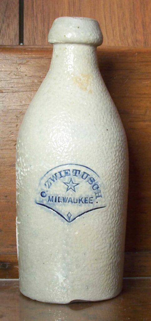 Bottle made by Hermann. We know this because this same stamp was also used on jugs with fishtail handle finishes, a telltale trait of jugs made by Hermann. 