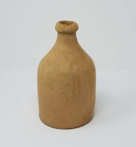 We attribute this earthenware bottle to a Whitewater pottery based on the color and glaze. 8" tall. Private collection.