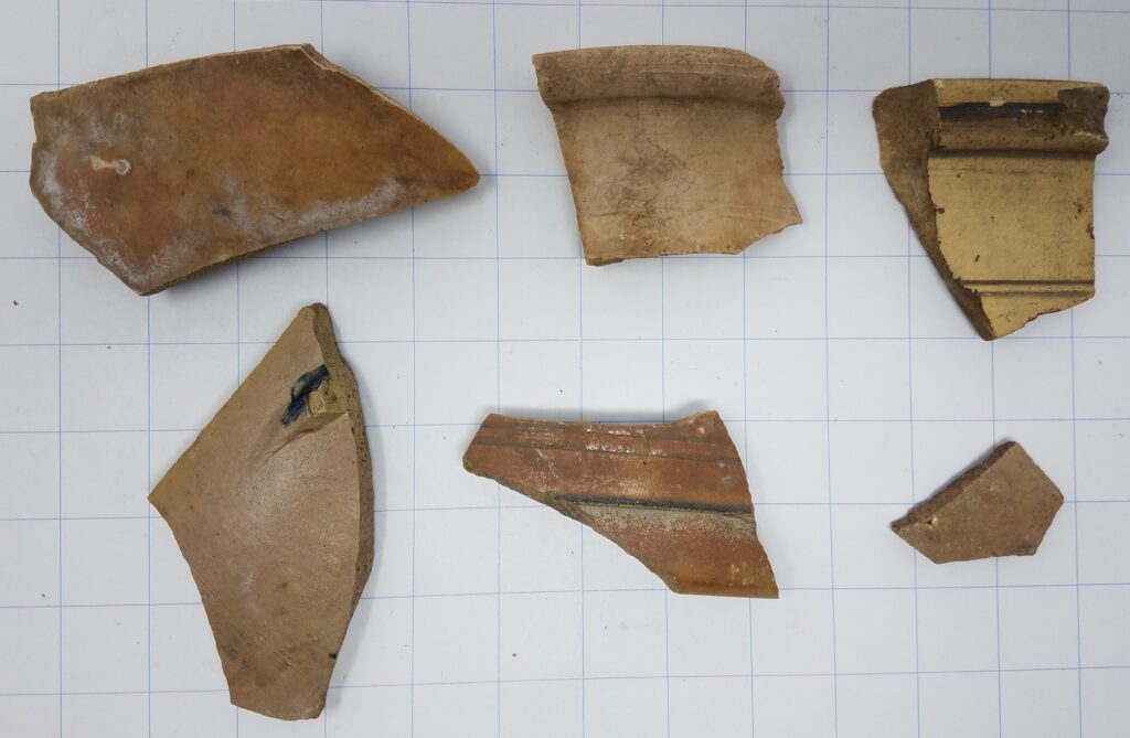 Assorted sherds with light colored glazes.. The piece in the upper right has an uncharacteristic square rim.