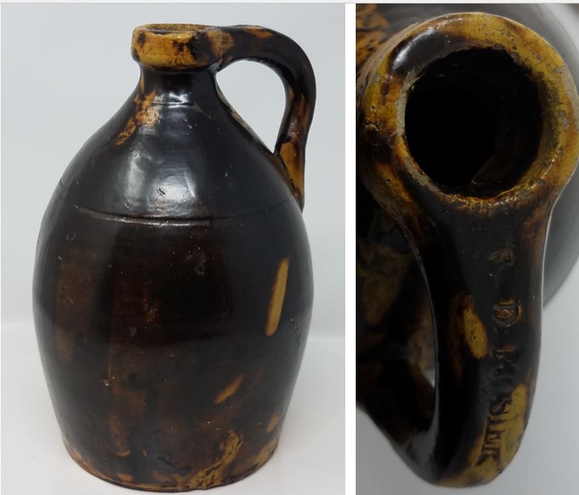 One gallon earthenware jug with a handle and one incised line and a heavy dark blown lead glaze..It is stamped "W.D. MOSIER" on the handle. Private collection.