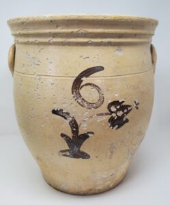 Whitewater six-gallon cream pot with and unusually light cream colored lead glaze and manganese flower decoration under a painted "6" with ear handles and a single incised line. Glaze loss on Whitewater pottery was a common and widespread problem due to the porous clay used. Large pieces like this rarely survived. Private collection.