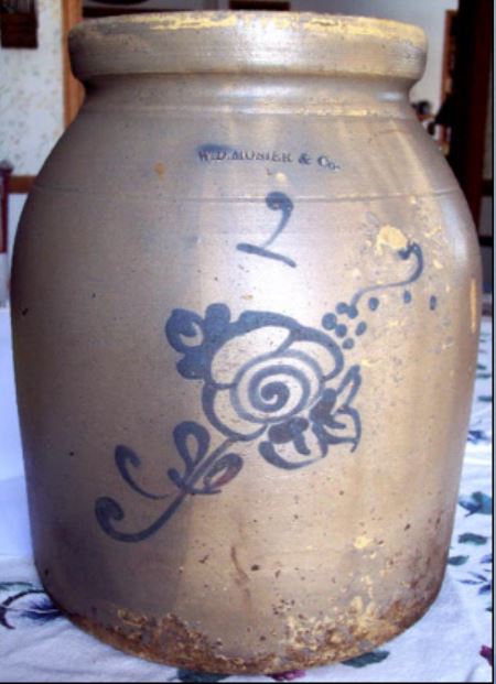 Two-gallon earthenware food storage jar stamped W.D. MOSIER & CO. with a script "2" and slip trailed flower in cobalt. Very few decorated Mosier pieces are in collections today.