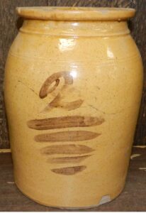 Lead glazed jarthenware jar with a flat rim and two incised lines. The manganese decoration is semi-transparent - a "2" with five lines below. Private collection.