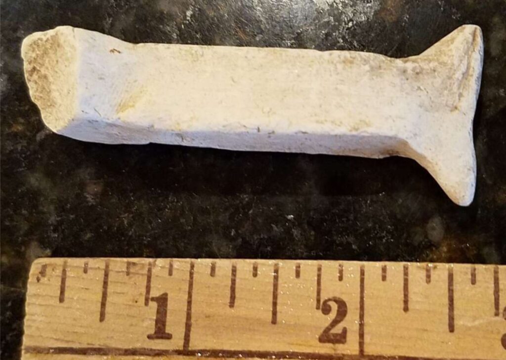 This unglazed fragment appears to be a tool designed for some unknown purpose, possibly for shaping or smoothing pottery on the wheel or some other function.