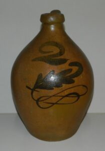 Whitewater two-gallon jug with a clear lead glaze and the fern and scroll manganese decoration under a large painted "2". Private collection.