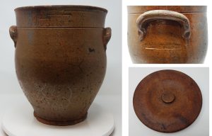 It is stamped "WHITE WATER" below the ear
and on the front. The front stamp is hard to read so it may have been stamped again to get a more legible mark.  Note the ear handle attachment, pedestal base, and highly ovoid form. The glazeis imperfect, probably during the ealry years of operation of the Fremoint Street pottery in the 1840's. The lid apprears to be original to the piece. It is masde of pressed wood particles. This piece was found in Palmyra in the Knapp-Calkins property. There is an 1840's cabin, a small house that was built later and a cream city brick home built around 1880. No other pots or shards have been found with this stamp as of 2026. It may be the oldest stamped intact piece of Wisconsin pottery known.